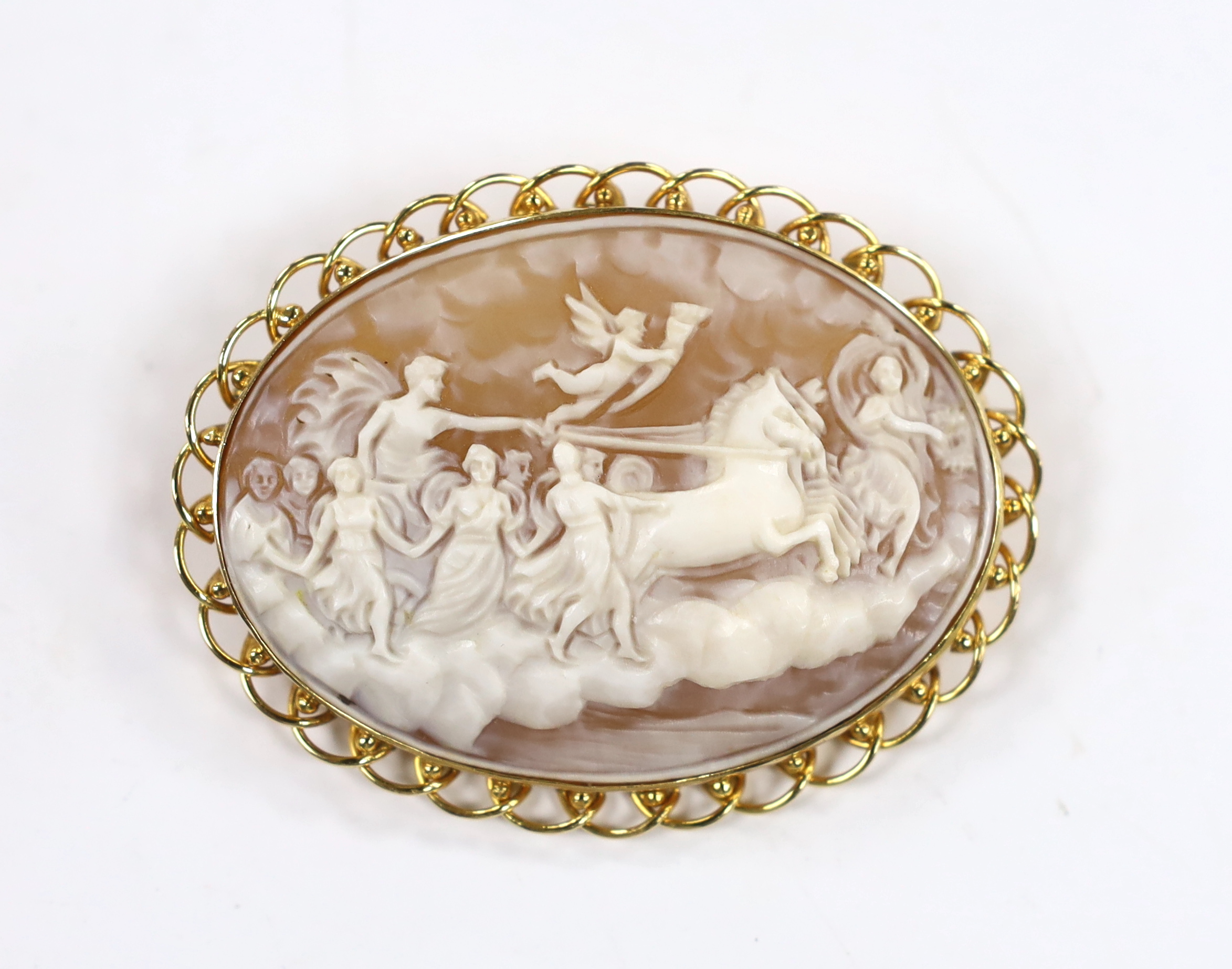 A modern 18k mounted oval cameo shell pendant brooch, carved with Phoebus and the hours preceded by Aurora, 58mm, gross weight 16 grams.